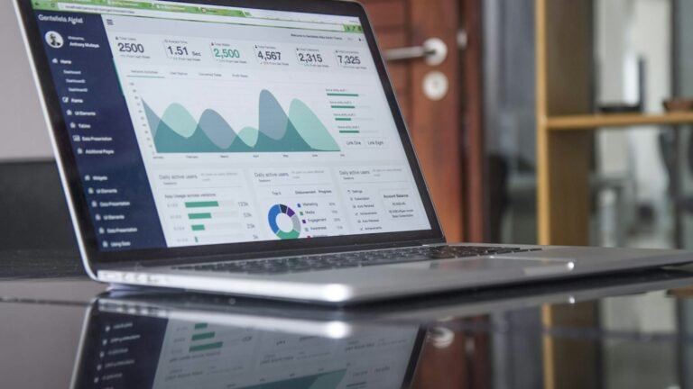 Laptop showing an analytics dashboard with growth charts