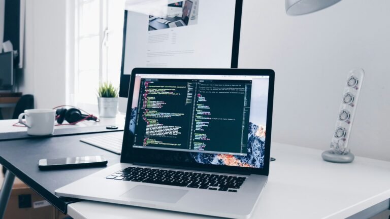 Laptop displaying code on a bright desk