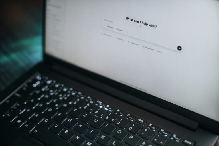 Laptop screen showing an AI chatbot prompt asking what it can help with