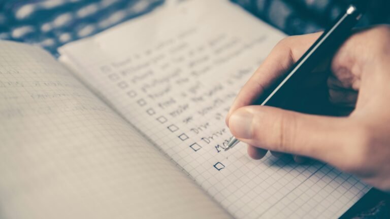 Hand writing a checklist in a notebook