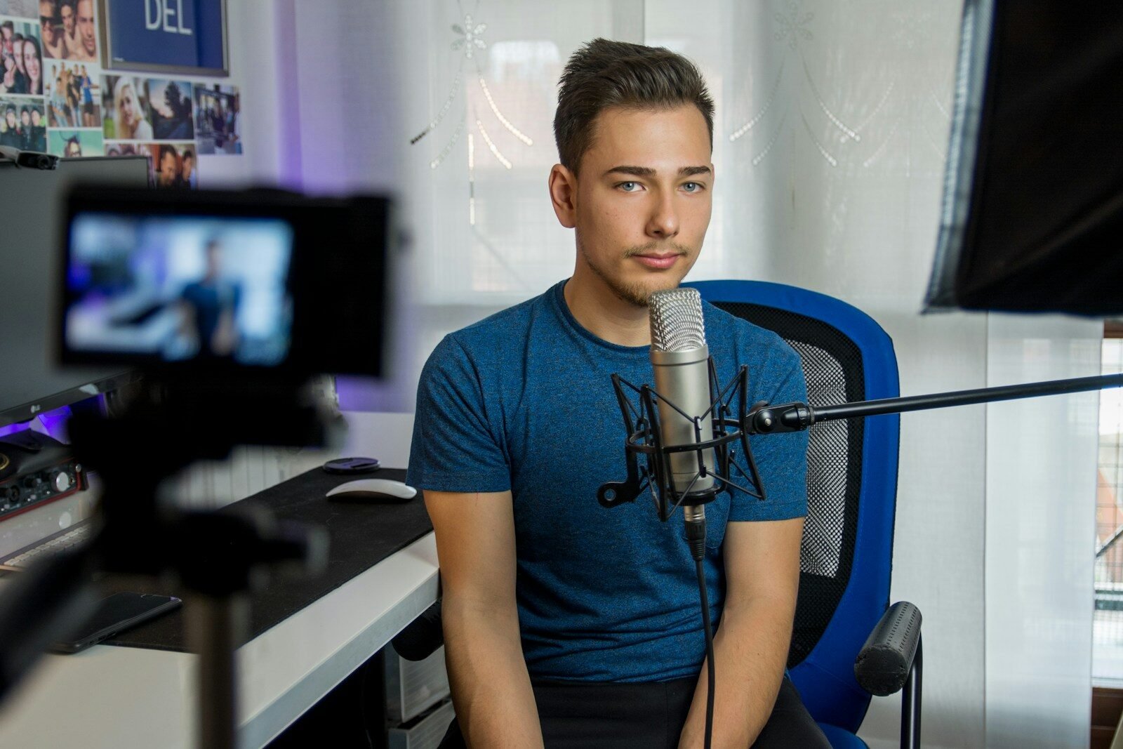Creator recording in front of a condenser microphone for a YouTube video