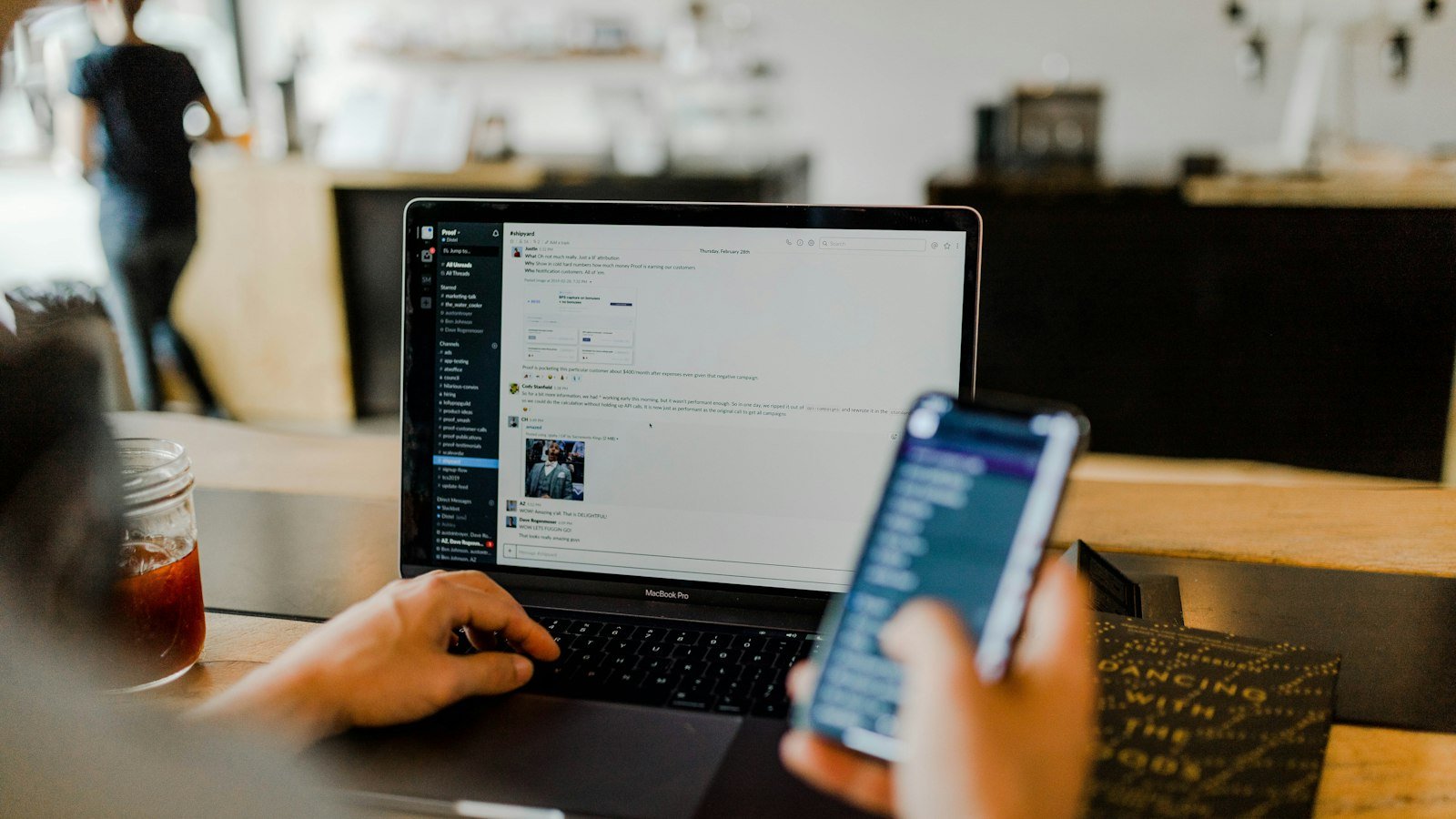 Person managing online sales on a laptop and phone